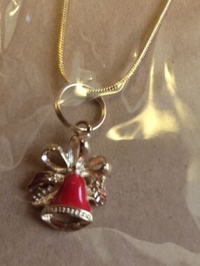 Gold-Tone Red Bell Pendant Necklace with Bow Accent